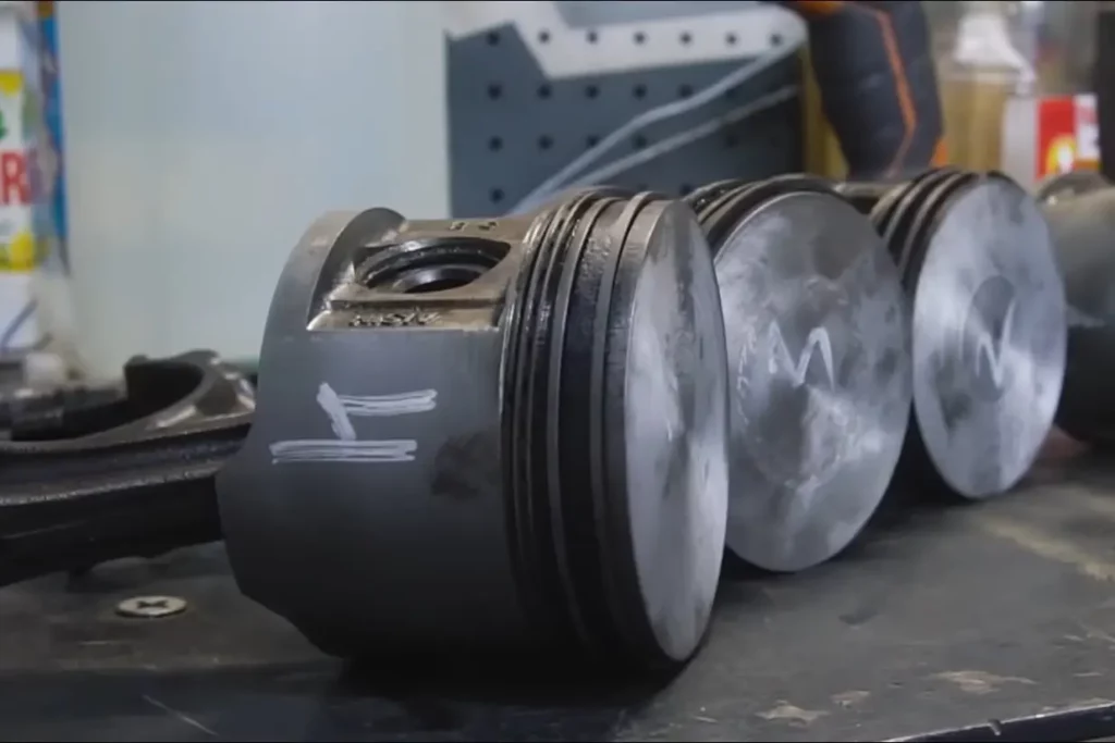 Pistons machined to adjust compression ratio. - YouTube/Garage 54