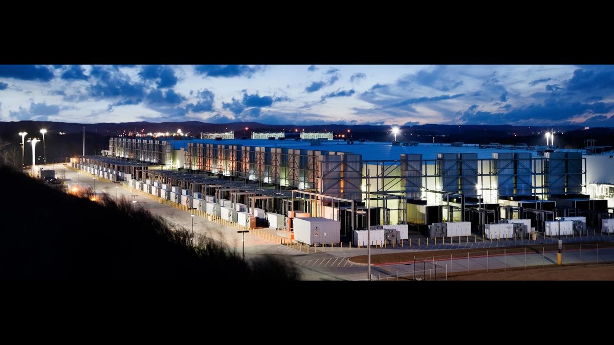 Google data center lit up at night