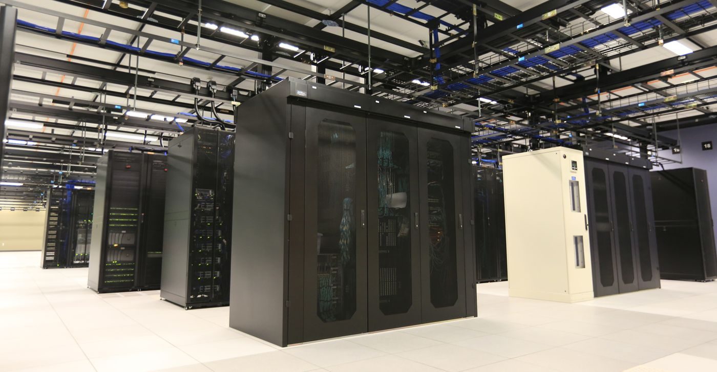 Server hall with rows of data center cabinets for AI infrastructure investment